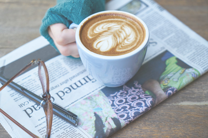 Cup of coffee on newspaper